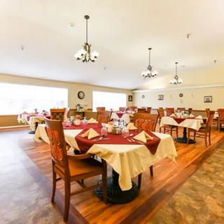 A well-appointed dining room with elegantly set tables and comfortable chairs.