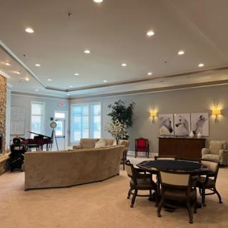 A spacious and luxurious living room featuring a modern interior design with comfortable seating and a dining area.