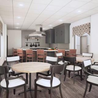 A modern kitchen and dining area with sleek furniture and ample lighting.