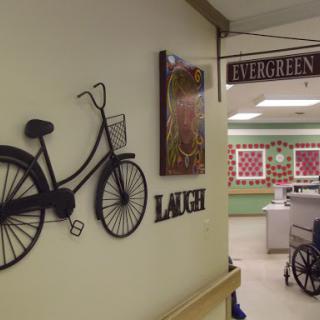 A cozy lounge area decorated with bicycle wall art and signs guiding visitors.
