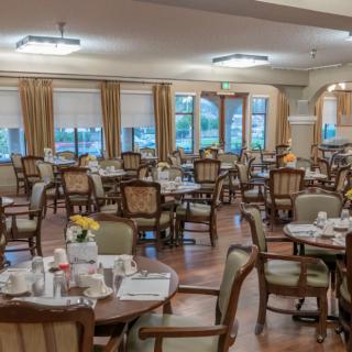 An elegant dining area with neatly arranged tables and chairs, awaiting guests.