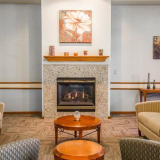 A cozy living room with a fireplace and comfortable seating area.