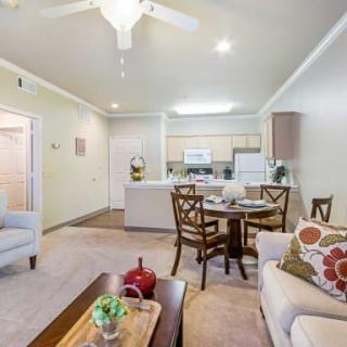 A cozy and modern open-plan living space featuring a dining area, kitchen, and comfortable seating.