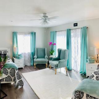 A bright and modern living room with turquoise accents and cozy furnishings.