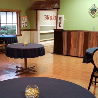 Interior view of an empty restaurant with round tables and a cozy atmosphere.