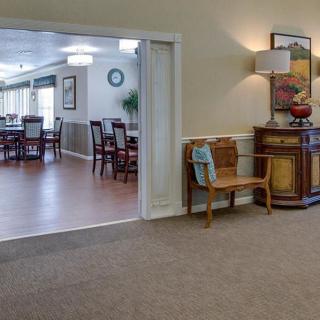 A cozy living space connected to a dining area, featuring elegant furniture and tasteful décor.