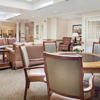 A bright and welcoming lounge area with comfortable seating and tables.