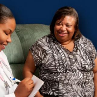 A doctor and patient engaging in a friendly consultation.