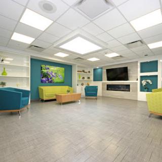 A modern and inviting waiting area featuring colorful furniture and bright lighting.