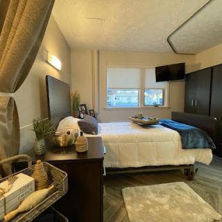 A cozy and modern bedroom featuring stylish furniture and soft lighting.