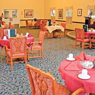 An elegant dining room with set tables and chairs, ready for guests.