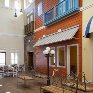 Indoor space designed to resemble an outdoor street scene with colorful facades and seating.