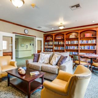 Cozy living room with bookshelves and comfortable seating.