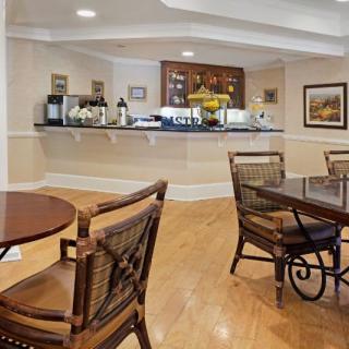 Cozy cafe interior with a coffee station and wooden furniture.