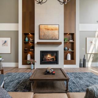 A modern living room with a central fireplace, elegant shelving, and stylish decor.