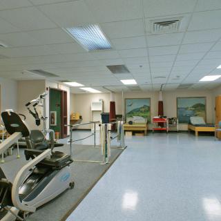 An empty gym with exercise equipment and workout machines.