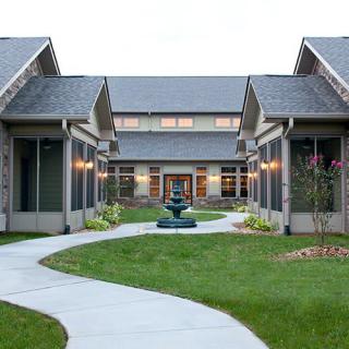 A modern courtyard with a central pathway and landscaped gardens.