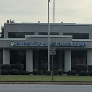 A modern commercial building featuring a prominent sign.