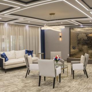 A modern living room with elegant furniture and stylish ceiling lighting.