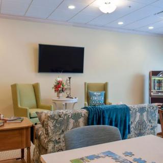 A cozy living room setup with a television, comfortable seating, and decorative elements.