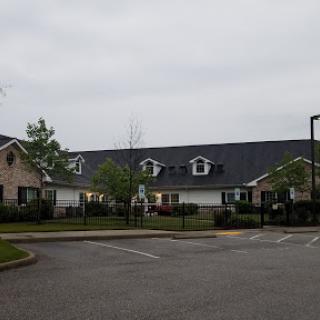 A view of a residential area featuring buildings under a cloudy sky.