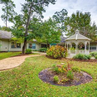 A serene garden with a gazebo, surrounded by lush greenery and a winding pathway.