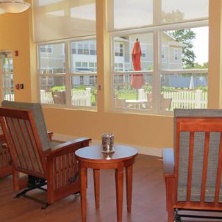 A cozy living room with large windows and comfortable seating.