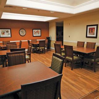 A modern conference room with tables and chairs arranged for meetings.