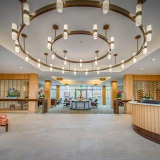 A modern and luxurious lobby featuring stylish chandeliers and a spacious reception area.