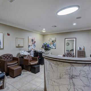 A modern salon interior with a cozy waiting area and stylish decor.