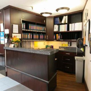 A well-organized office reception area with a desk and bookshelves.