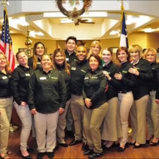 A team of dedicated employees posing together in a professional environment.