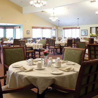 A well-arranged dining room with neatly set tables and comfortable chairs.