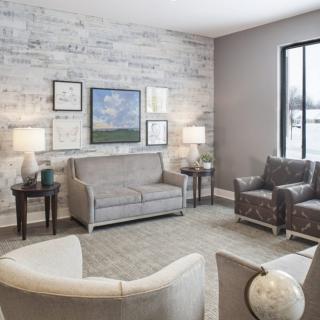 A cozy and modern living room with neutral tones, featuring comfortable seating and elegant decor.