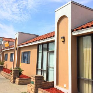 A modern residential building with a tiled roof and well-maintained exterior.