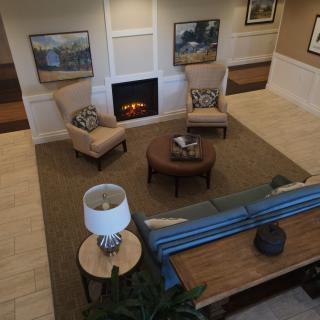 A cozy living room with comfortable seating arranged around a fireplace.