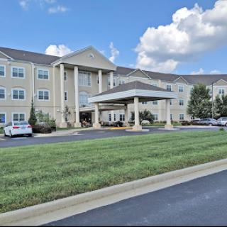 A modern hotel building showcasing classic architectural design under a clear blue sky.