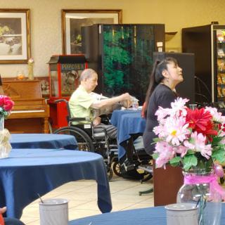 Residents enjoying time in the activity room of a senior living facility.