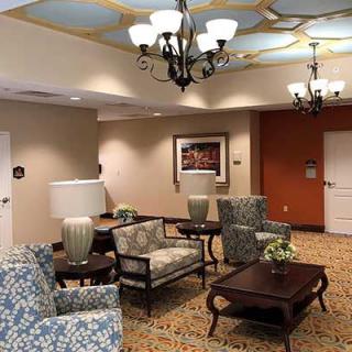 A hotel lobby with comfortable seating and elegant lighting.