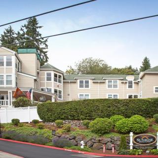 A residential building surrounded by lush greenery and manicured landscaping.