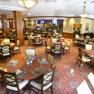 Spacious dining area with elegantly arranged tables and chairs in a restaurant.