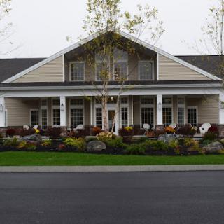 A beautifully landscaped residential home featuring a welcoming entrance.