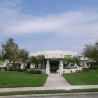 A view of a law school building with surrounding greenery and a clear sky.