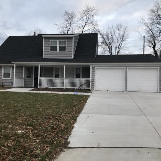 A suburban house with a two-car garage and a wide driveway.
