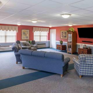 A spacious living room with comfortable seating and a large television.