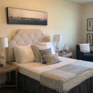 A cozy bedroom with elegant decor and comfortable furnishings.