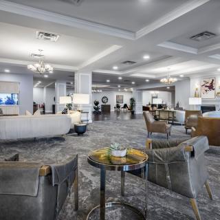 A spacious and elegantly designed hotel lobby with modern furniture and ambient lighting.