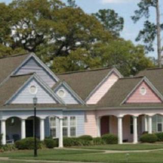 Colorful houses with porches in a residential neighborhood.