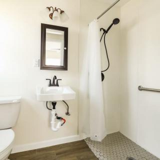 A modern, accessible bathroom with a walk-in shower and minimalist design.