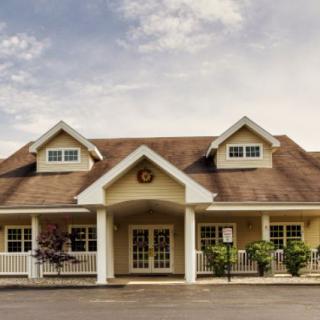 A charming residential house with a front porch and gabled roof.